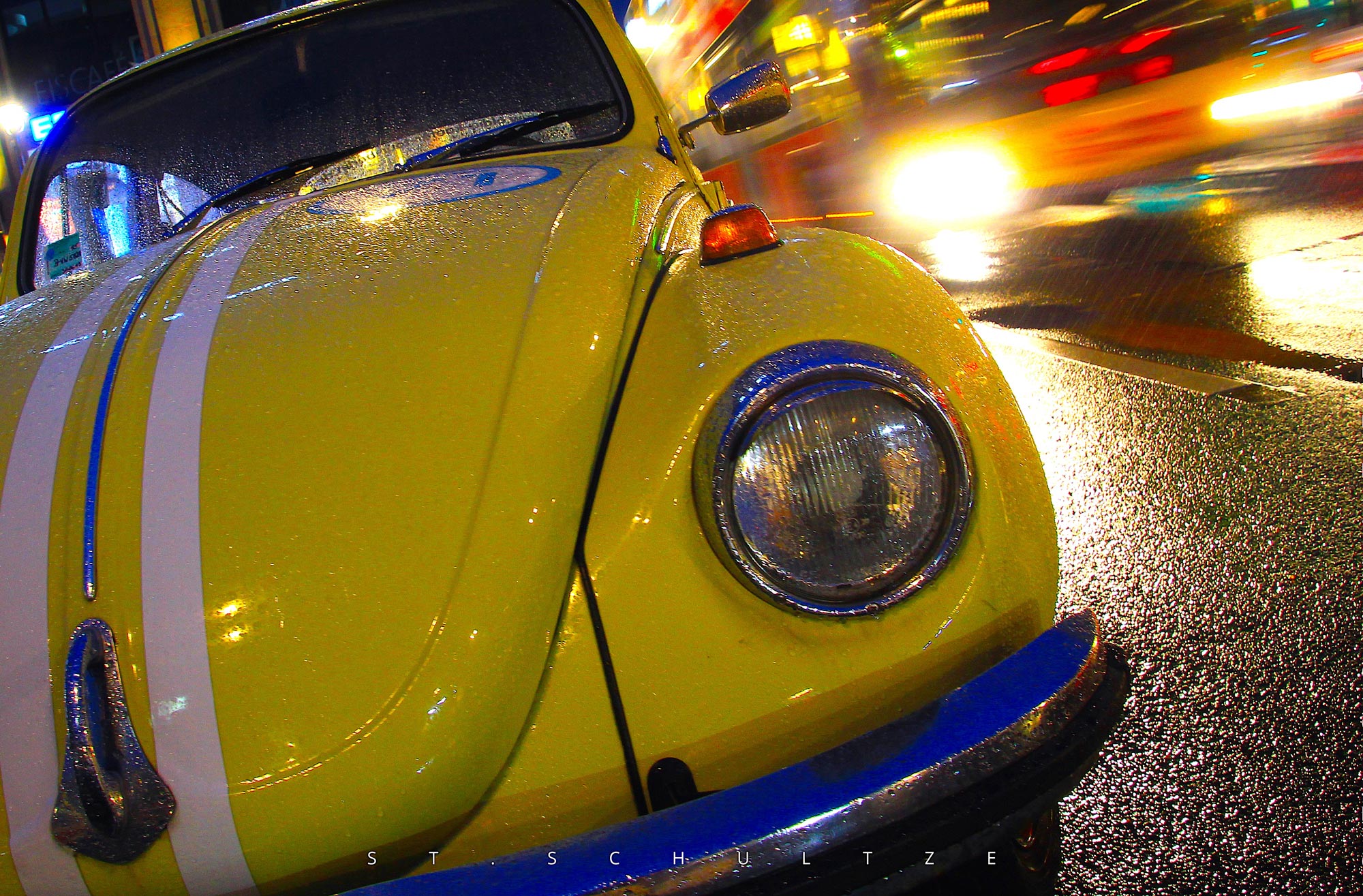 One that always makes people smile: A well restaurated beautiful vintage VW Beetle oldtimer in Berlin on a rainy day while a Bus passed by – vintage automotive PHOTOGRAPHY by Stefan Schultze. vintage car, vwbeetle, iconic car, Berlin oldtimer, mobility, car photography. iconic photography